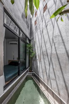 an indoor swimming pool in front of a concrete wall