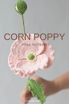 a crocheted flower with the words corn poppy free pattern in front of it