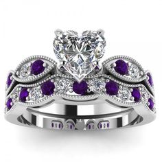 Capture her heart with this sweet ring set. Beautifully crafted in sterling silver, this entrancing design features a shimmering heart cut stone at the center and alternating purple and white stones arranged between intricate milgrain borders. On your wedding day, seal your vows and celebrate your commitment with the coordinating wedding band. A great anytime choice, this ring set is sure to become an instant favorite. Carat Weight: 3.065 ctStone Size: 8*8 mmStone Type: Jeulia® StoneNumber of Stones: 1 Stone Color: Diamond WhiteStone Shape: HeartCarat Weight: 2.28 ctStone Size: 2 mmStone Type: Jeulia® StoneNumber of Stones: 27 Stone Color: Diamond White, Amethyst PurpleStone Shape: RoundWeight: 6 gWidth: 10.9 mmHeight: 7.4 mmThickness: 4.9 mmMaterial: 925 SilverPlating Color: Silver White Sapphire Wedding Set, Sapphire Wedding Set, Womens Wedding Ring Sets, Blue Wedding Rings, Ruby Wedding Rings, Sterling Silver Rings Set, Purple Jewelry, Silver Ring Set, Bridesmaid Jewelry Sets