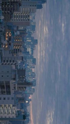 an aerial view of skyscrapers and clouds in the sky