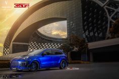 a blue car parked in front of a building