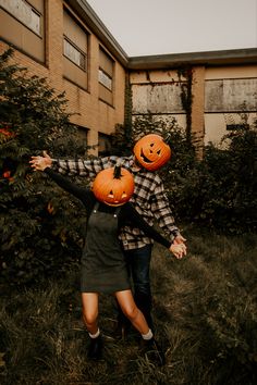 two people with pumpkins on their heads