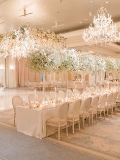 an elegant wedding reception with chandeliers and flowers