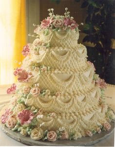 a three tiered wedding cake decorated with flowers