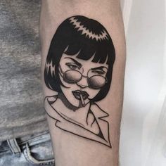 a woman with glasses and a scarf on her arm is shown in this black and white tattoo