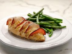 a white plate topped with meat and green beans