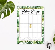 the bridal bingo game is next to some sunglasses and a green leafy plant