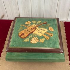 a green box with a musical instrument painted on it