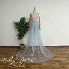 a mannequin wearing a blue wedding dress with a long veil on it's head