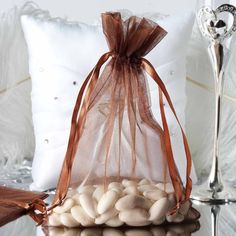 a bag filled with white beans sitting on top of a table next to a pillow