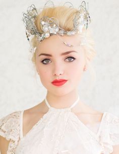 a woman with blonde hair wearing a tiara