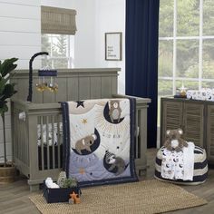 a baby crib with two teddy bears in it and other items on the floor