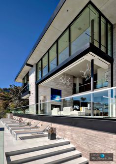 an exterior view of a modern house with stairs leading up to it