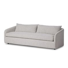 a white couch with two pillows on it's back and one arm facing the camera