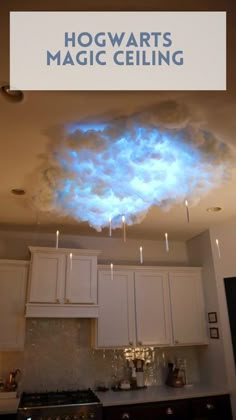 there is a blue cloud in the middle of this kitchen ceiling that has lights on it