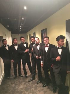 a group of men in tuxedos standing next to each other