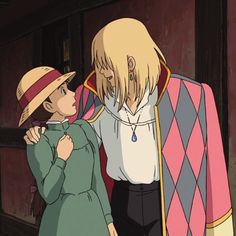 two people standing next to each other in front of a blue frame with an anime character