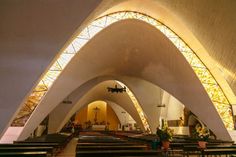 the inside of a church with rows of pews