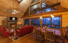 a living room filled with furniture and a fire place in the middle of a room