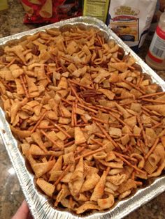 a pan filled with cheetos sitting on top of a counter