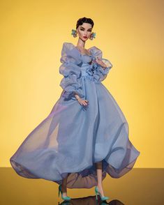 a barbie doll wearing a blue dress and high heels