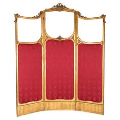 an ornately decorated gold and red screen with two panels on each side, set against a white background