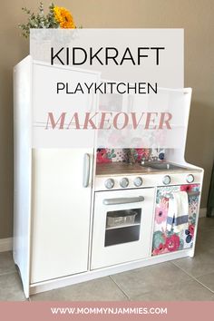 a white stove top oven sitting inside of a kitchen next to a flower vase with yellow flowers