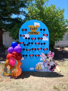 a mickey mouse game with balloons on the ground