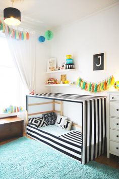 a child's bedroom with a bunk bed and blue carpet