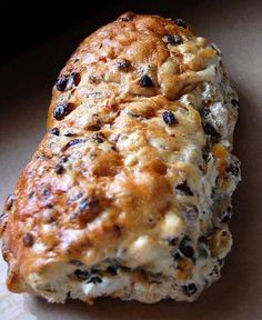 a piece of bread with raisins and cheese on it sitting on a table