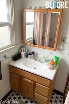 a bathroom sink sitting under a mirror next to a window