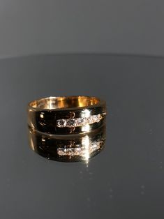 This Men's band is a classic diamond wedding band for the man who loves a little bling. It has a simple minimalist look with the channel style of setting the diamonds. Details: Size: The ring is a Size 12.5( can be sized upon request) The center stone is: Diamond Approximately .40ct G color/ SI1 clarity. Gram weight is: 9.5 grams Metal: 14K yellow Gold. The thickness at the top is 7.35mm and it tapers down at the bottom to 4.18 mm Every Antique piece of jewelry we sell at Heirloom Pavé has been 5 Gold Rings, Ring Gold Wedding, 5 Stone Ring, Diamond Ring Gold, Wedding Band Diamond, Funky Rings, Diamond Ear Cuff, Wedding Ring Sizes, Etsy Gold Ring