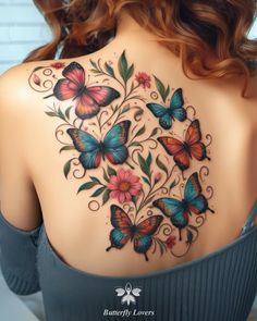 the back of a woman's shoulder with butterflies and flowers tattoo on her chest