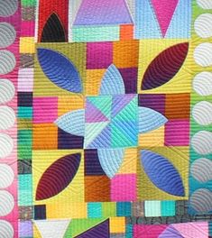 a colorful quilt with many different designs on the front and back pieces, all in bright colors