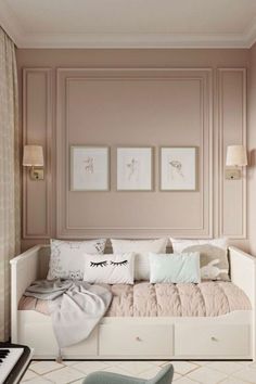 a room with a couch, piano and pictures on the wall above it in shades of pink