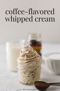 coffee - flavored whipped cream in a glass jar with spoons next to it