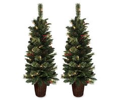 two artificial christmas trees with lights on them