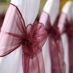 red and white chair sashes are tied together