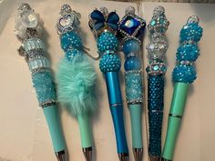 four pens with blue and green decorations on them