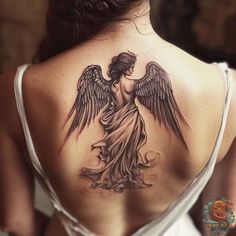 a woman with an angel tattoo on her back