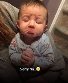 a woman holding a baby with her eyes closed and the caption says sorry na