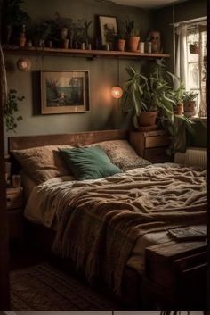 a bed sitting in a bedroom next to a window with potted plants on top of it