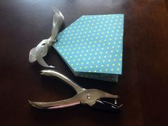 a pair of scissors and a paper origami on a table with polka dots