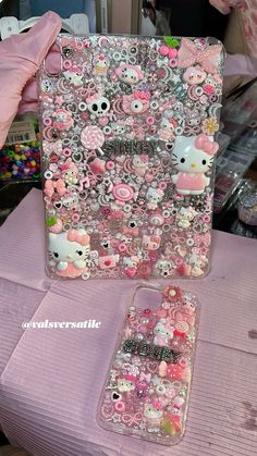 the hello kitty phone case is covered in pink and silver sequins, which are all over the place