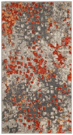 an orange and gray area rug with red flowers on the bottom, grey ground below