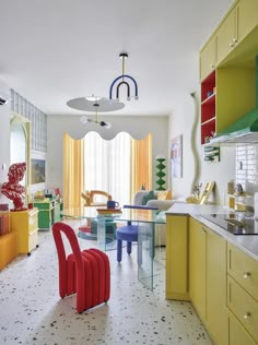 the colorful kitchen is clean and ready for us to use it's bright colors