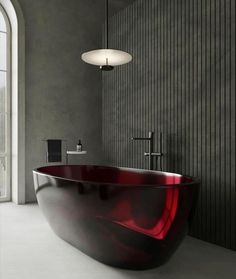 a bath tub sitting in the middle of a bathroom next to a wall mounted faucet