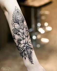 a woman's arm with flowers on it and the words explore written in black ink