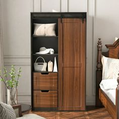 a bed sitting next to a wooden cabinet in a bedroom on top of a hard wood floor