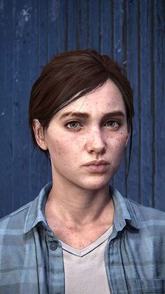 a woman with freckles on her face and blue shirt is looking at the camera